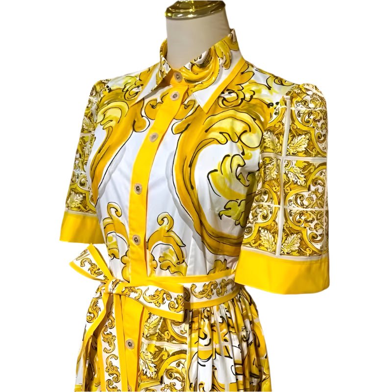 Yellow and white ornate print shirt dress with puff sleeves and tied waist, perfect for summer styling.
