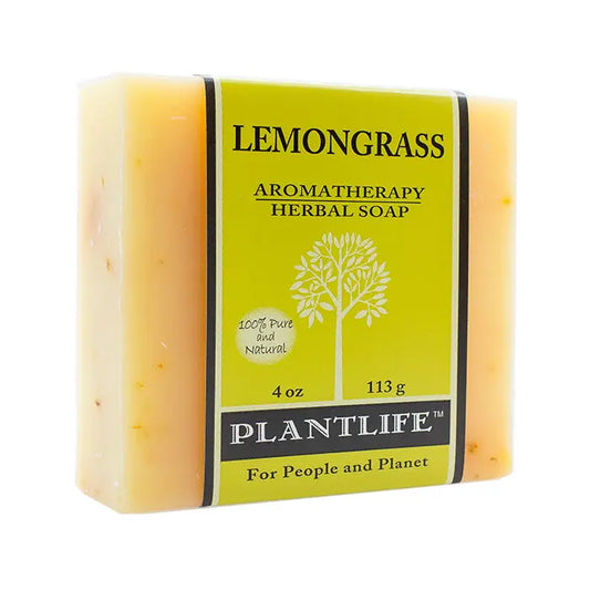 A rectangular bar of pale orange lemongrass soap wrapped in a green label featuring a tree logo.