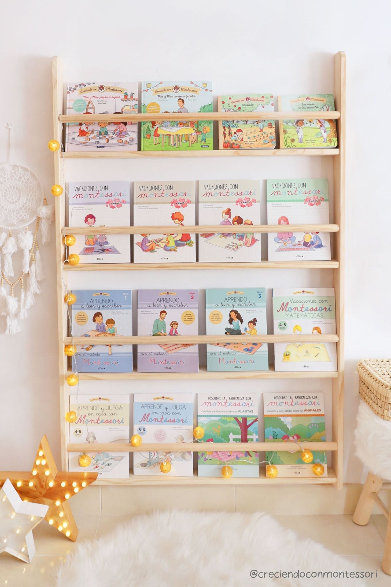Estantería de madera clara con libros educativos para niños, decorada con luces cálidas y estilo Montessori.