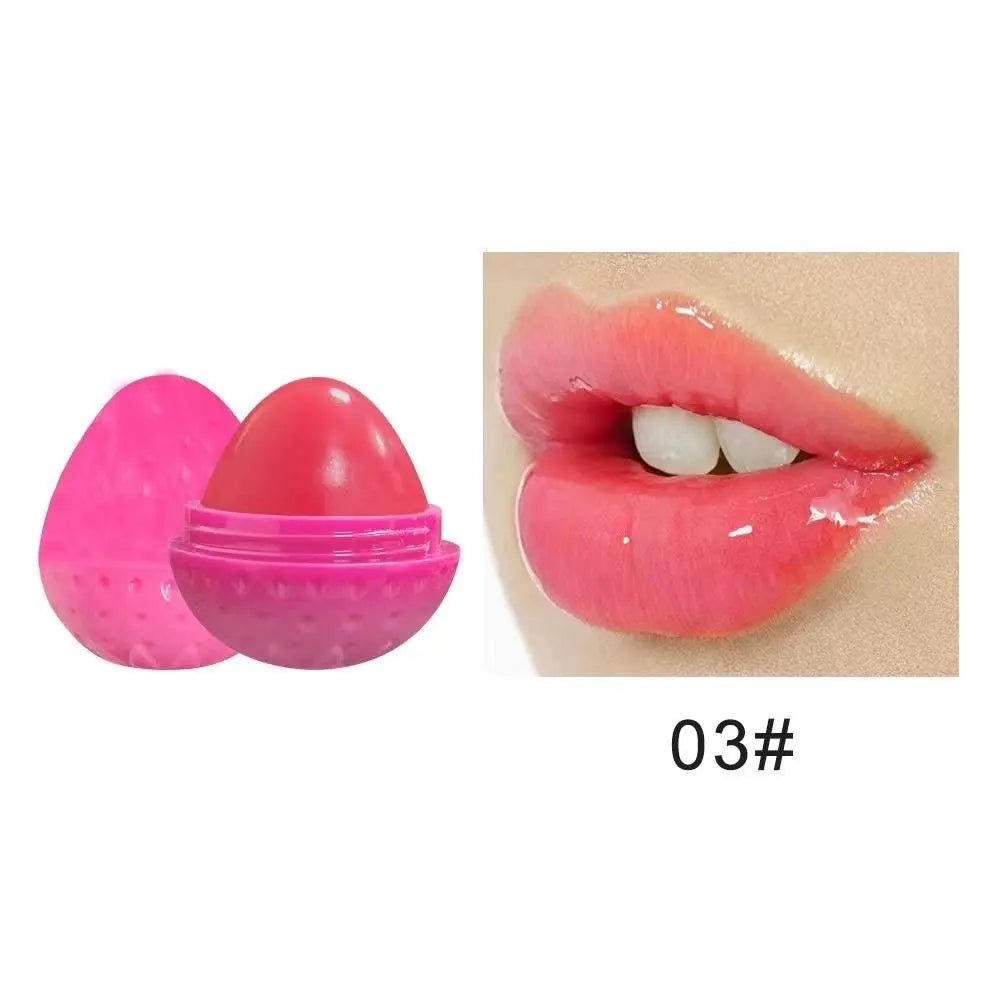 Pink strawberry-shaped lip butter container and lips with glossy pink application, labeled 03#.