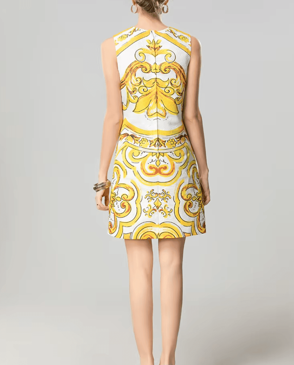White and yellow patterned sleeveless dress, featuring a stylish fitted design, perfect for summer events.
