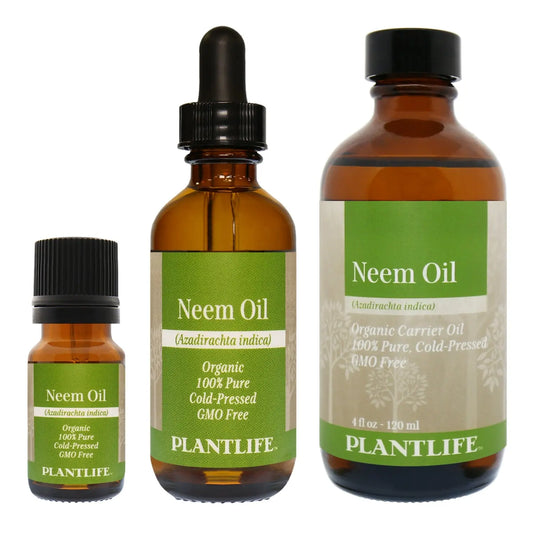 Three amber glass bottles of Plantlife Neem Oil with green labels of varying sizes against a white background.