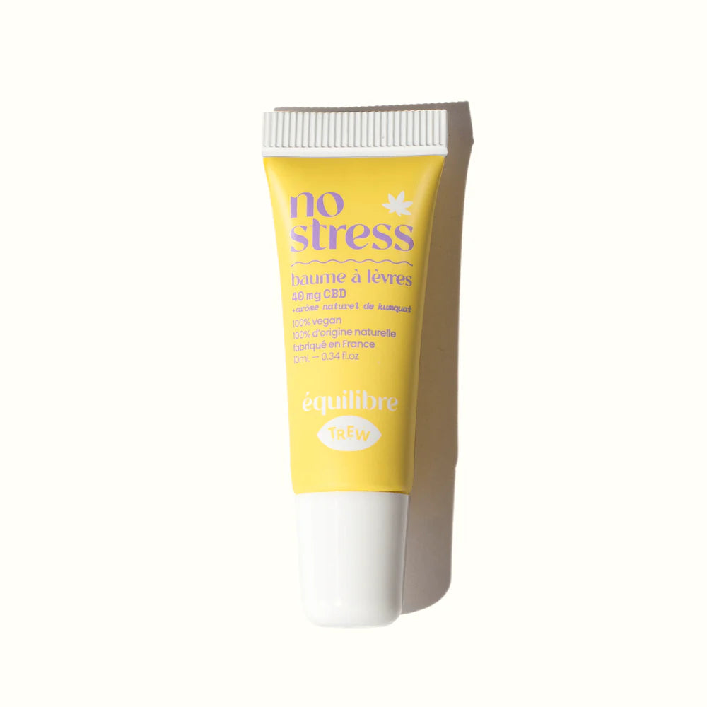 Yellow lip balm tube with purple text reading "no stress" and a white screw cap on a white background.