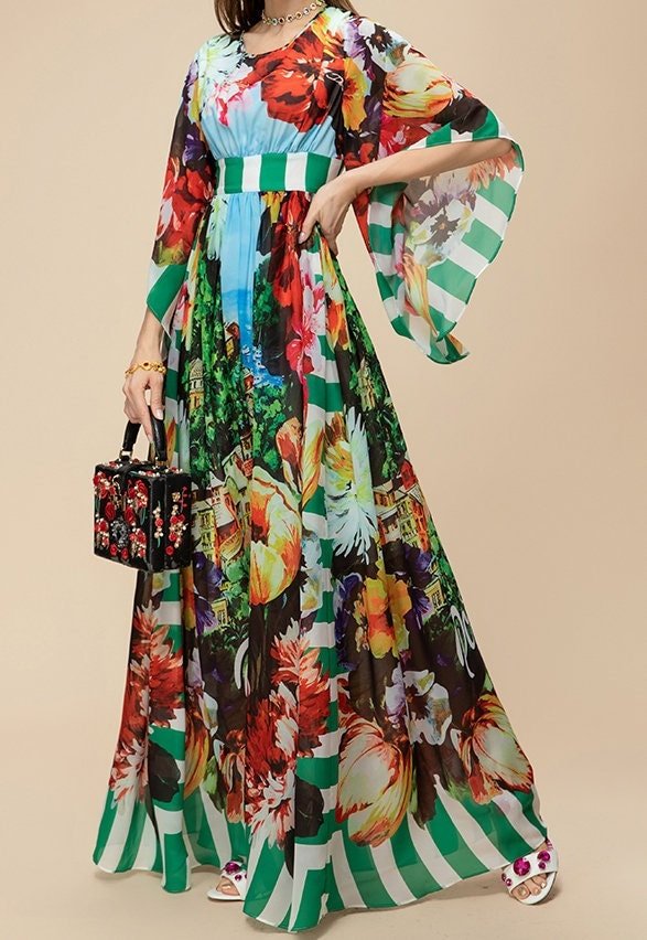 Floral maxi dress with green striped accents, lightweight fabric, and elegant flowing sleeves, perfect for summer events.