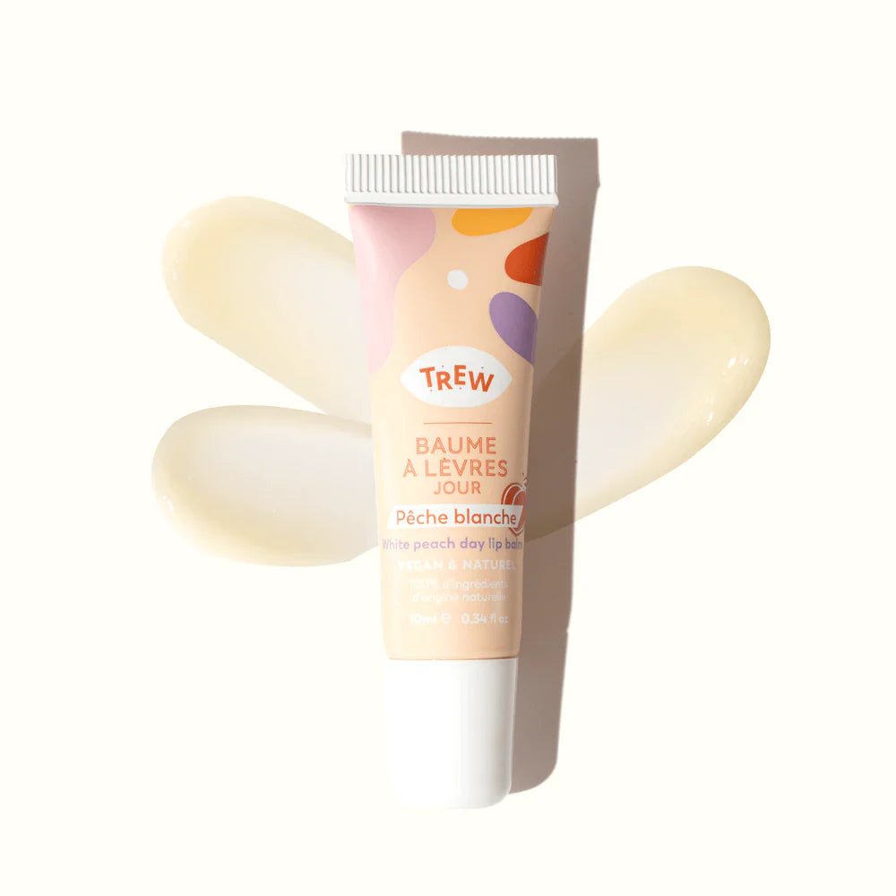 Trew white peach lip balm in a squeeze tube with colorful abstract shapes, displayed over creamy balm swatches.