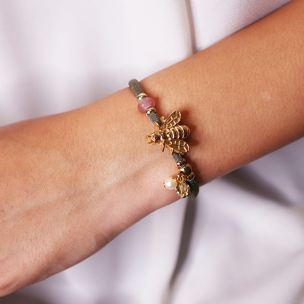 Pulsera de hilo gris con abeja dorada, perlas y piedras preciosas en estilo elegante y moderno.