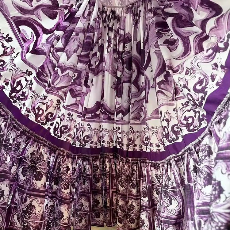 Lavender and white patterned maxi dress with ruffled detailing and vintage-inspired design. Perfect for summer outings.
