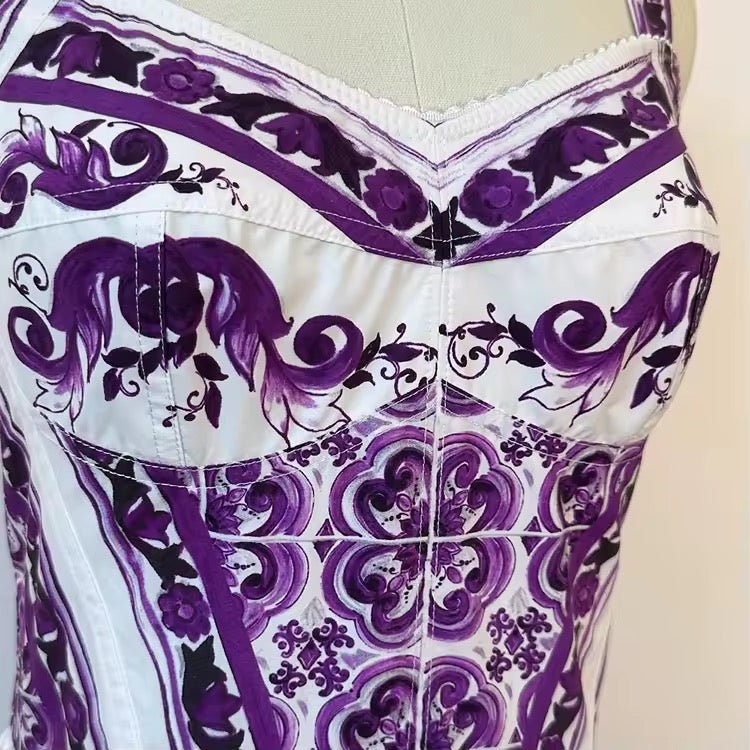 Purple floral print corset top, featuring elegant patterns on a white fabric, perfect for a stylish evening look.