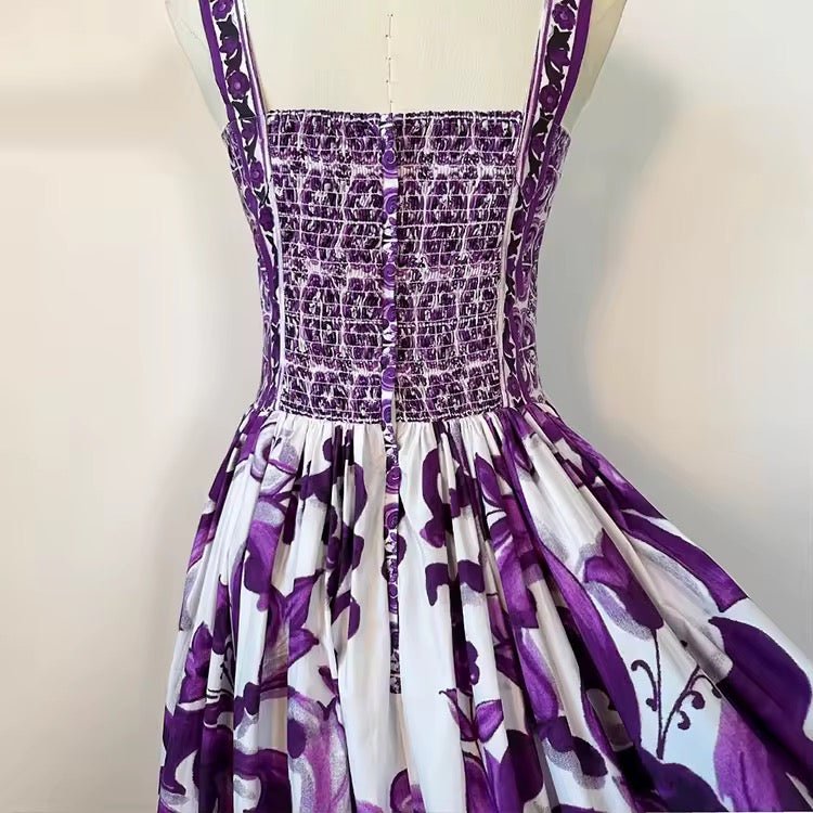 Purple floral smocked sundress with elegant buttons, crafted from lightweight fabric for summer styles.