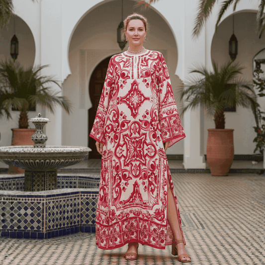 Red and white patterned kaftan dress, featuring long sleeves and side slits, perfect for summer occasions.