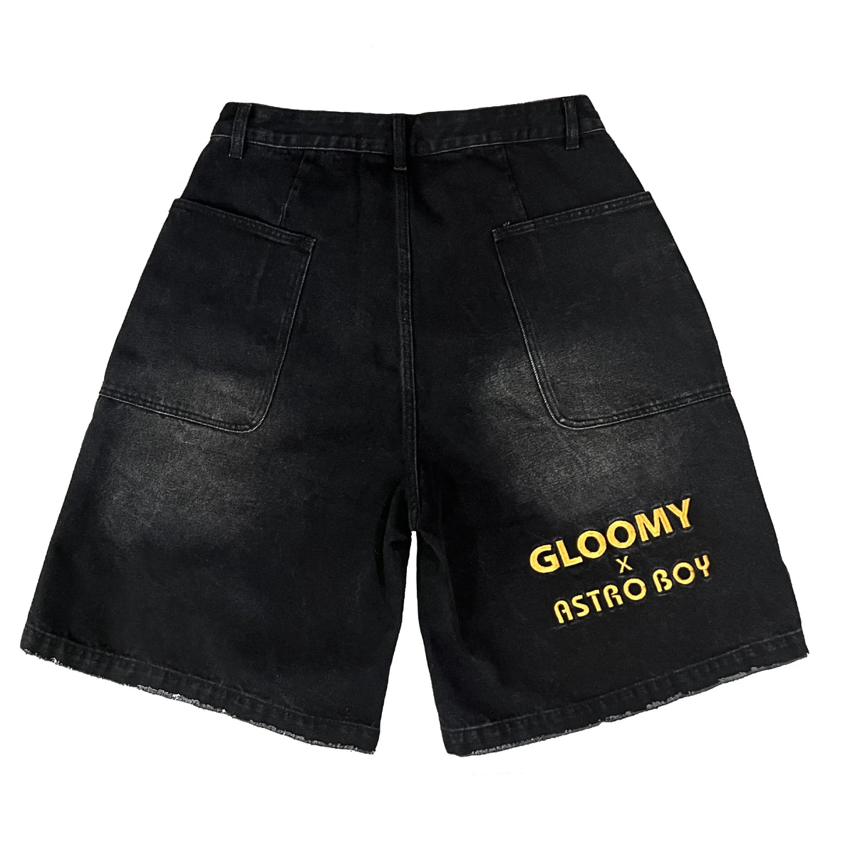 Black denim shorts with faded wash, large pockets, and "GLOOMY X ASTRO BOY" embroidered in yellow on the leg.