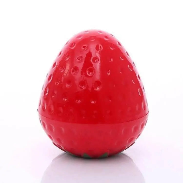 Glossy, bright red strawberry-shaped lip butter container with a textured surface on a white background.