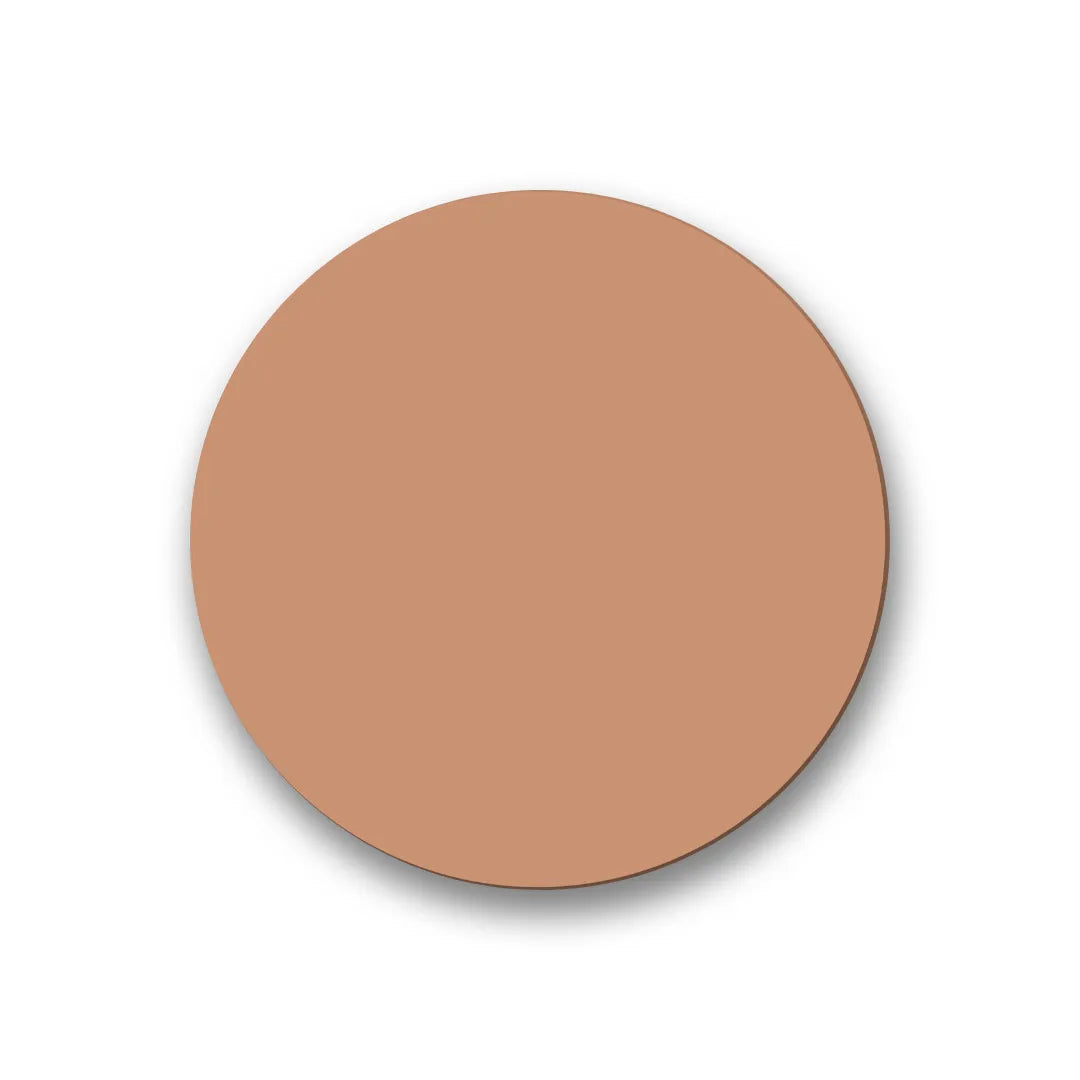 A smooth, circular swatch of light tan-toned cream foundation or concealer with a soft, matte texture.