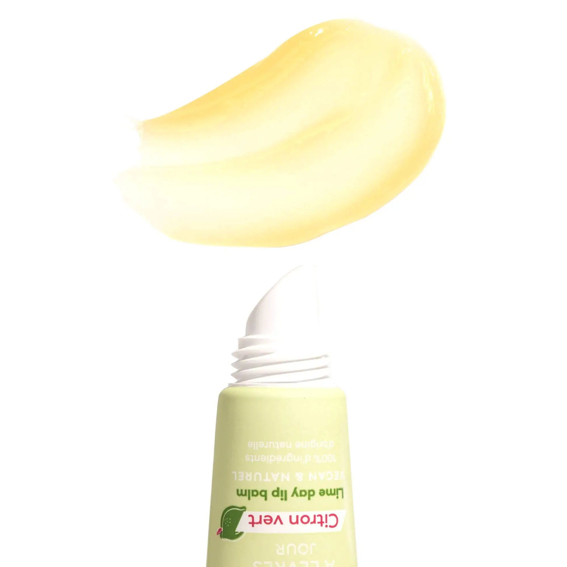 A pale green lime-scented lip balm tube with an angled applicator and a swatch of translucent yellow balm above it.